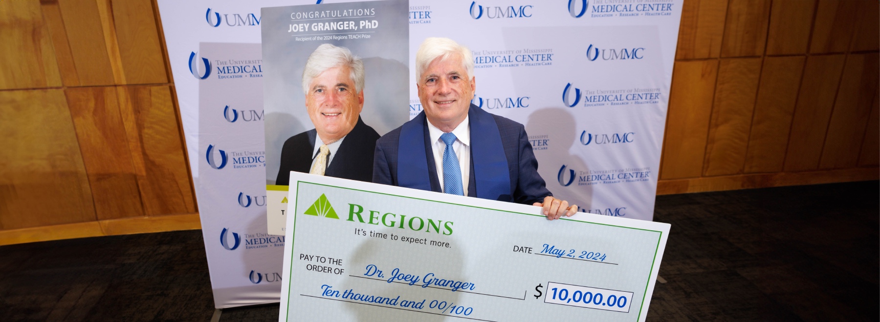 Photo of Dr. Granger hold Regions TEACH Prize check